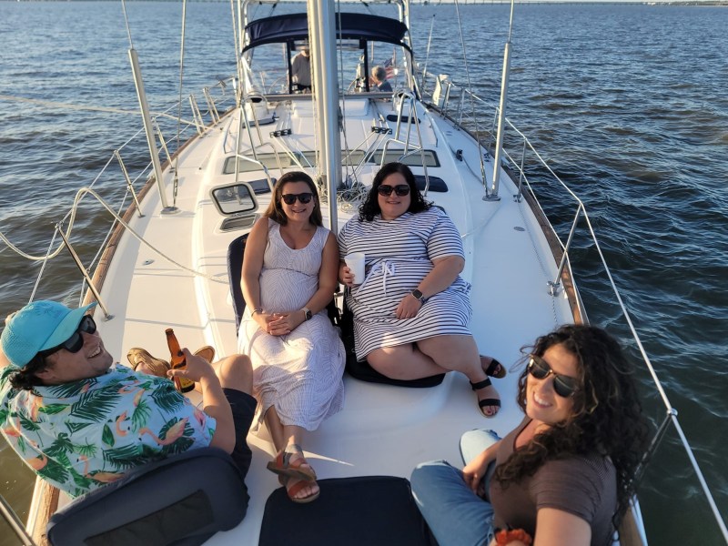 a group of people on a sailboat in the water